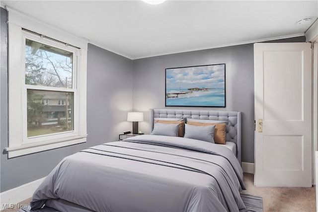 carpeted bedroom featuring crown molding