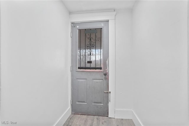 doorway to outside with light wood-type flooring