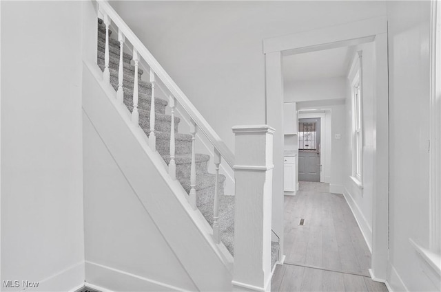 stairway with hardwood / wood-style floors