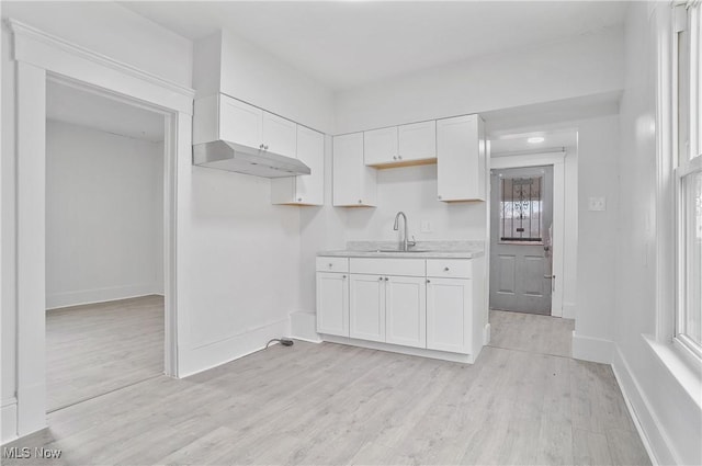 kitchen featuring sink, light hardwood / wood-style floors, and white cabinets