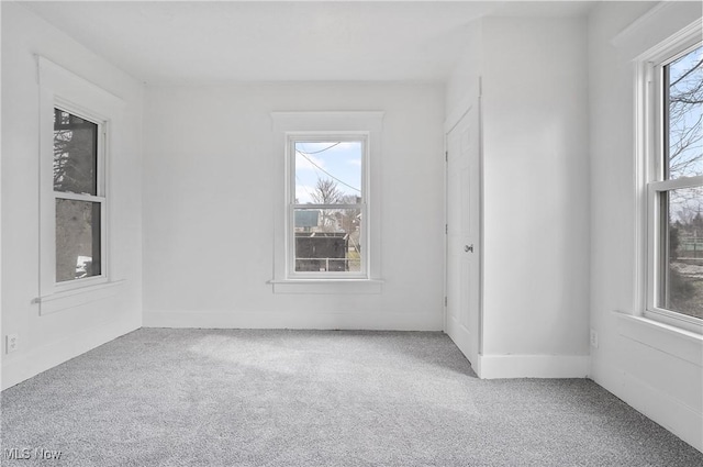 spare room featuring light colored carpet