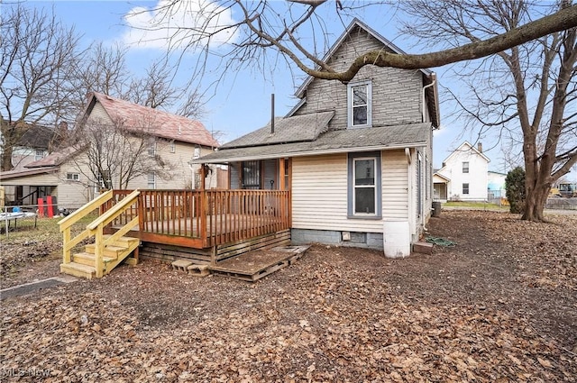 rear view of property featuring a wooden deck