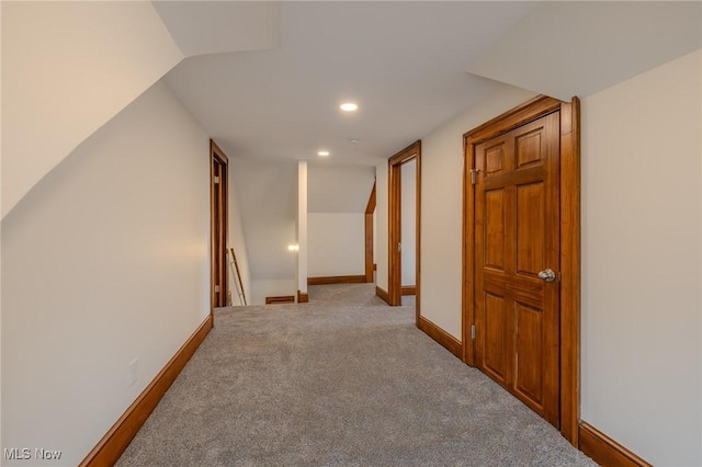 hallway featuring light carpet