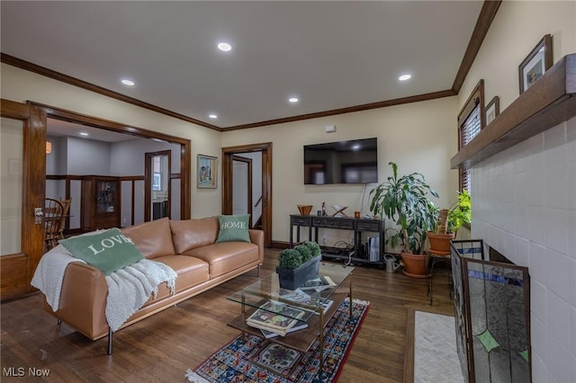 living room featuring a fireplace, crown molding, plenty of natural light, and dark hardwood / wood-style floors