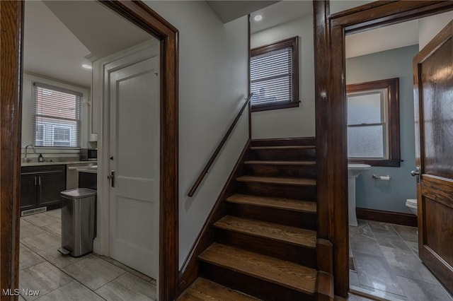 staircase featuring sink