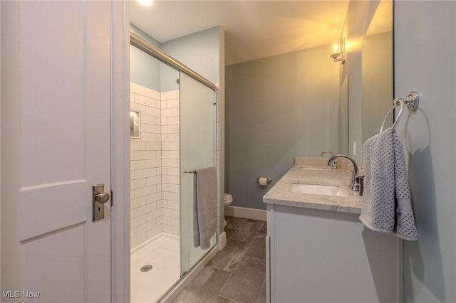 bathroom with vanity, an enclosed shower, and toilet