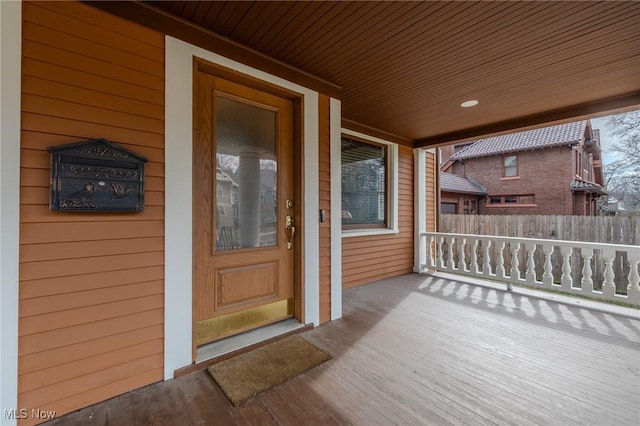 view of exterior entry with a porch