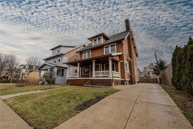 view of front of home with a front lawn and a porch