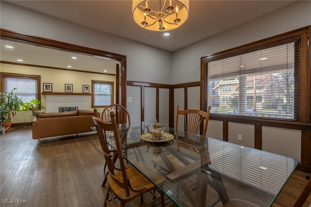 dining area with an inviting chandelier and hardwood / wood-style floors