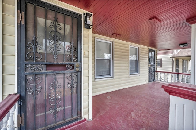 view of exterior entry featuring a porch