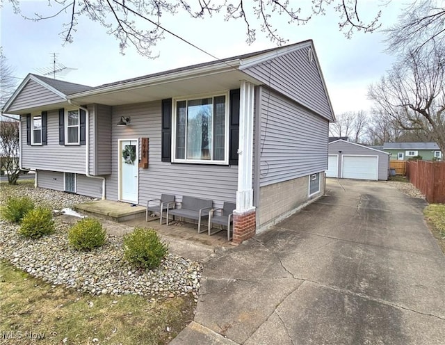 view of front of house with a garage and an outbuilding