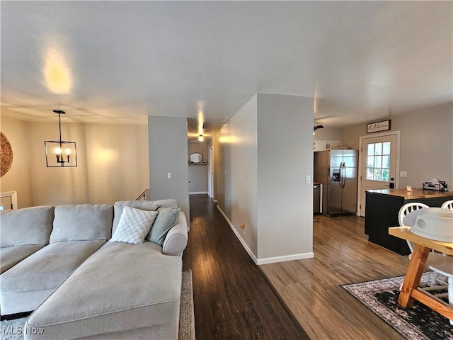 living room with hardwood / wood-style flooring and a notable chandelier