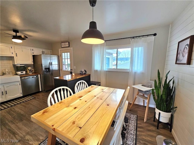 dining space with dark hardwood / wood-style flooring, a wealth of natural light, and ceiling fan