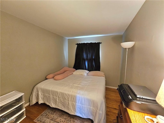 bedroom featuring dark hardwood / wood-style flooring