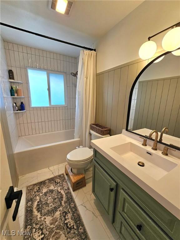 full bathroom featuring shower / bath combination with curtain, vanity, and toilet