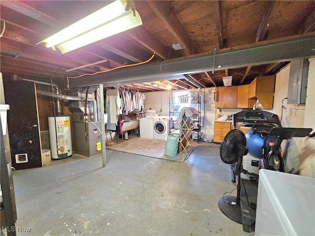 basement featuring heating unit, independent washer and dryer, electric panel, and water heater