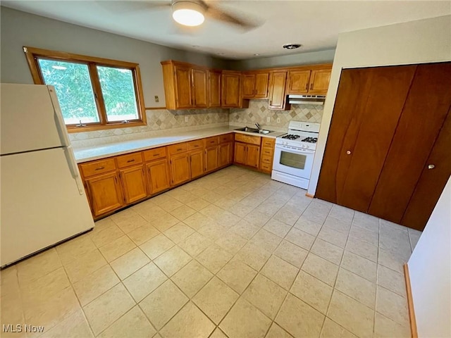 kitchen featuring ceiling fan, sink, white appliances, and decorative backsplash