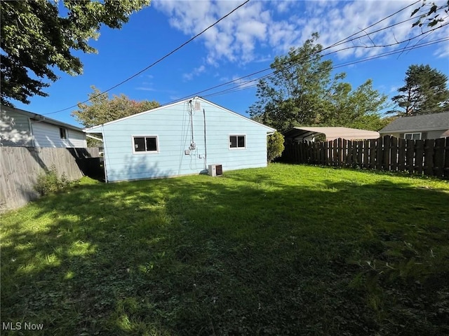 rear view of property featuring a lawn