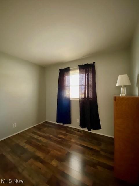 empty room featuring dark hardwood / wood-style floors