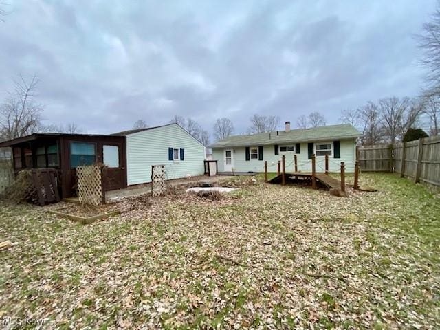 back of house with a lawn