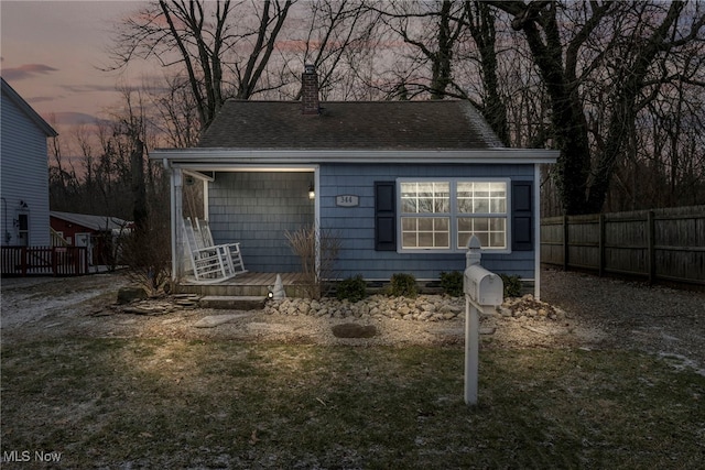 outdoor structure at dusk featuring a lawn