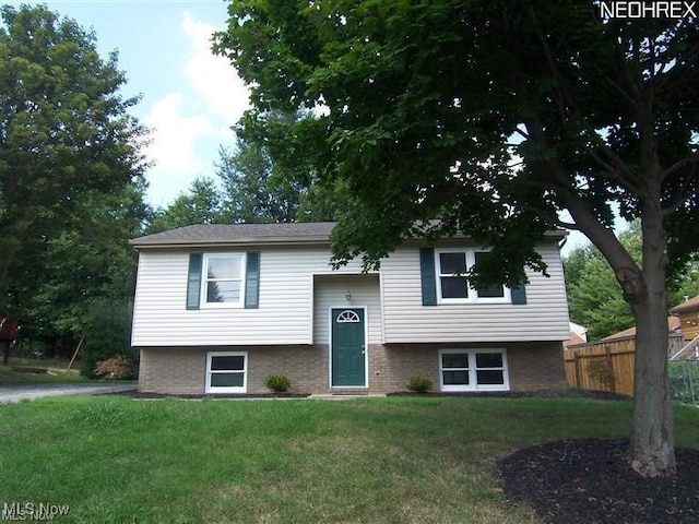 raised ranch with a front lawn