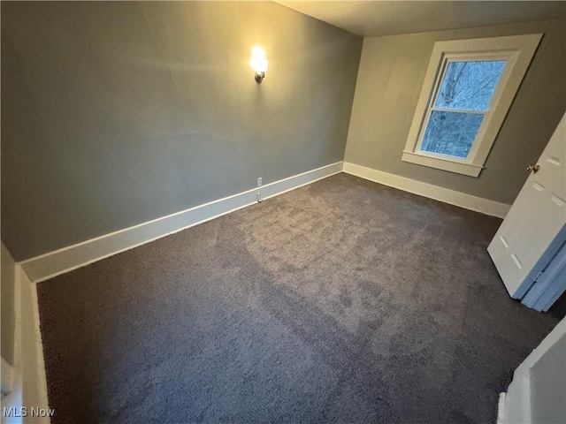 empty room with dark carpet