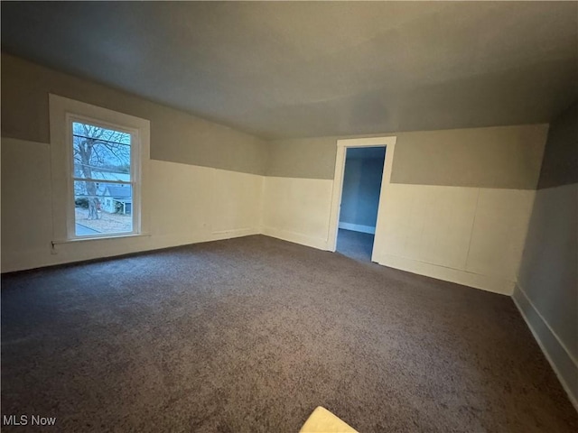 bonus room featuring dark colored carpet