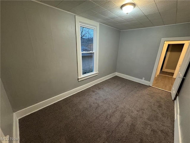 empty room with dark colored carpet