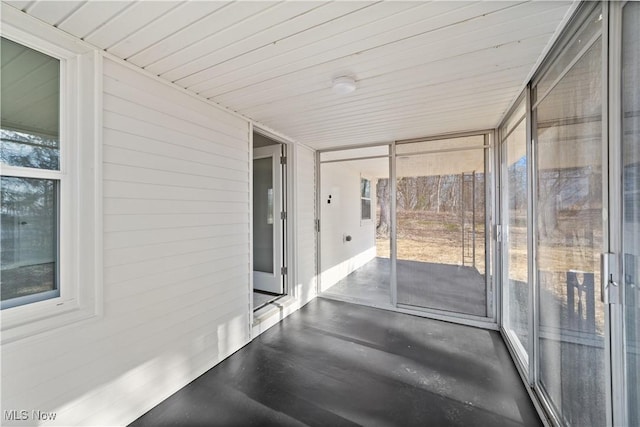 sunroom featuring wooden ceiling and a wealth of natural light