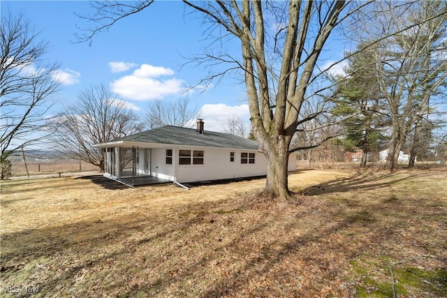 back of house with a lawn