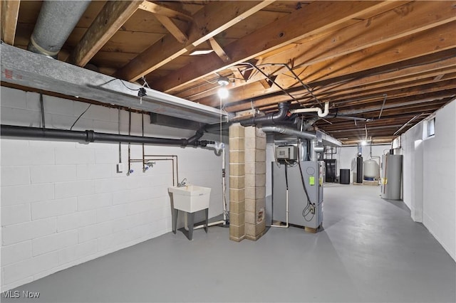 basement with water heater and sink