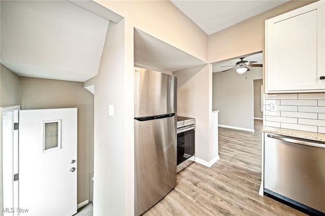 kitchen featuring white cabinetry, backsplash, light hardwood / wood-style flooring, and appliances with stainless steel finishes