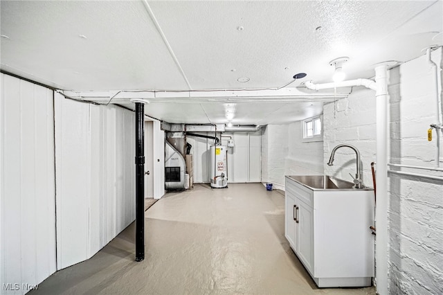 basement featuring sink, gas water heater, and a textured ceiling