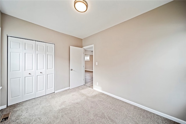 unfurnished bedroom with a closet and carpet