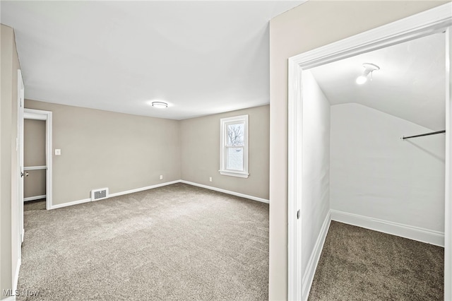 unfurnished bedroom featuring carpet floors and vaulted ceiling