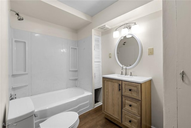 full bathroom featuring vanity, hardwood / wood-style floors, shower / tub combination, and toilet