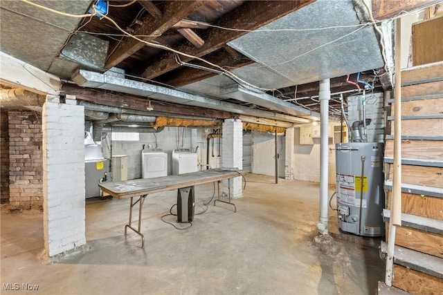 basement featuring washer and clothes dryer and water heater