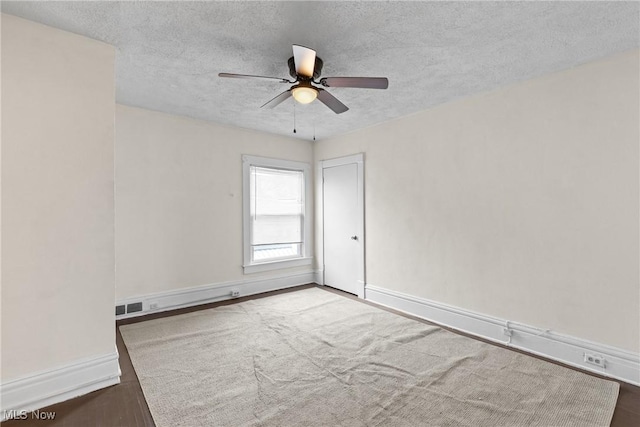 spare room featuring ceiling fan and a textured ceiling