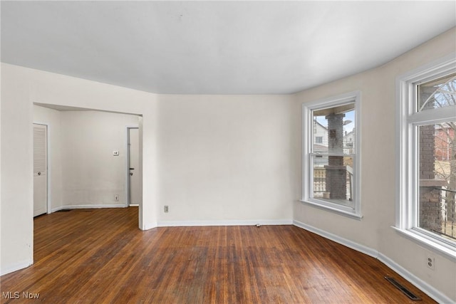 unfurnished room featuring dark wood-type flooring