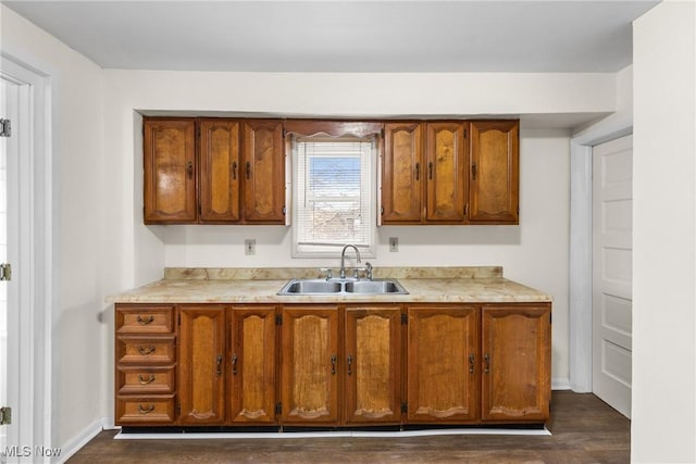 kitchen featuring sink and dark wood-type flooring