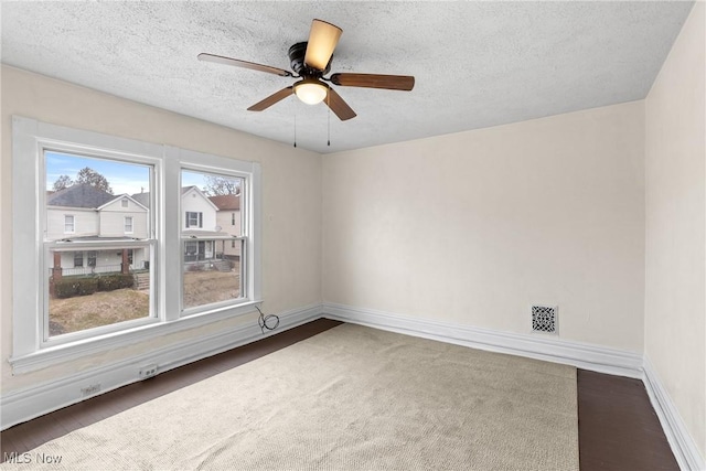 spare room featuring ceiling fan and a textured ceiling