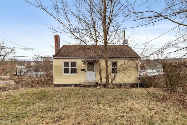 bungalow-style home with a front yard