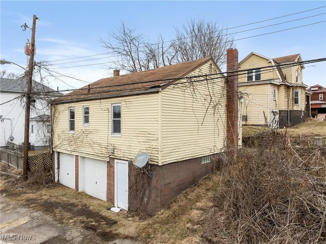 view of side of home featuring a garage