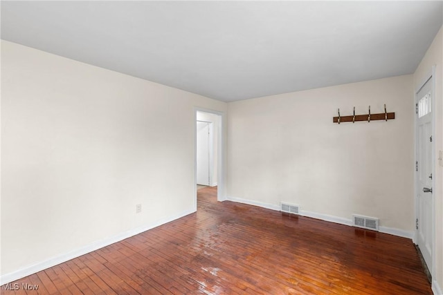 spare room featuring dark wood-type flooring