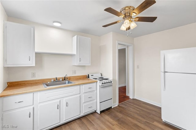 kitchen featuring hardwood / wood-style flooring, white appliances, sink, and white cabinets