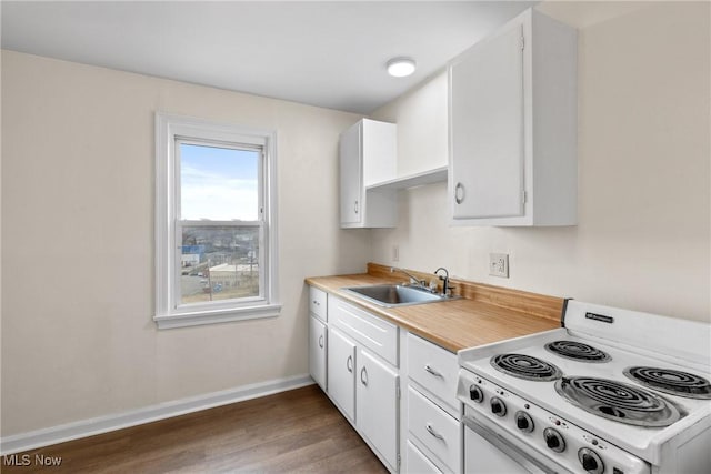 kitchen with sink, dark wood-type flooring, white electric stove, and white cabinets