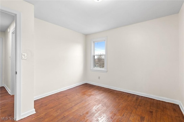 unfurnished room with hardwood / wood-style floors