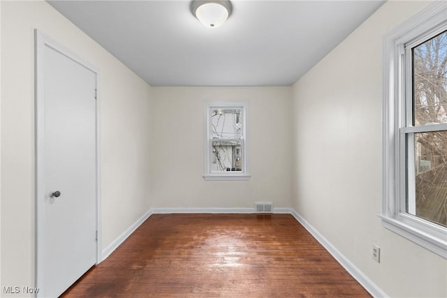 unfurnished room featuring dark hardwood / wood-style flooring