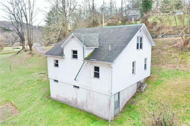 view of side of home featuring a yard